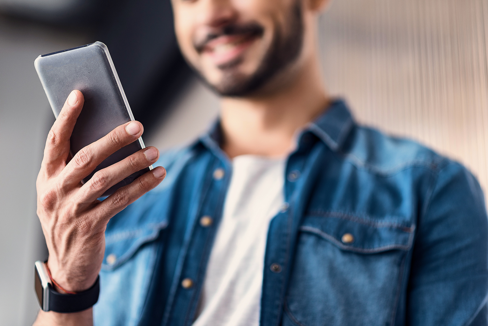 Merry man keeping modern smartphone