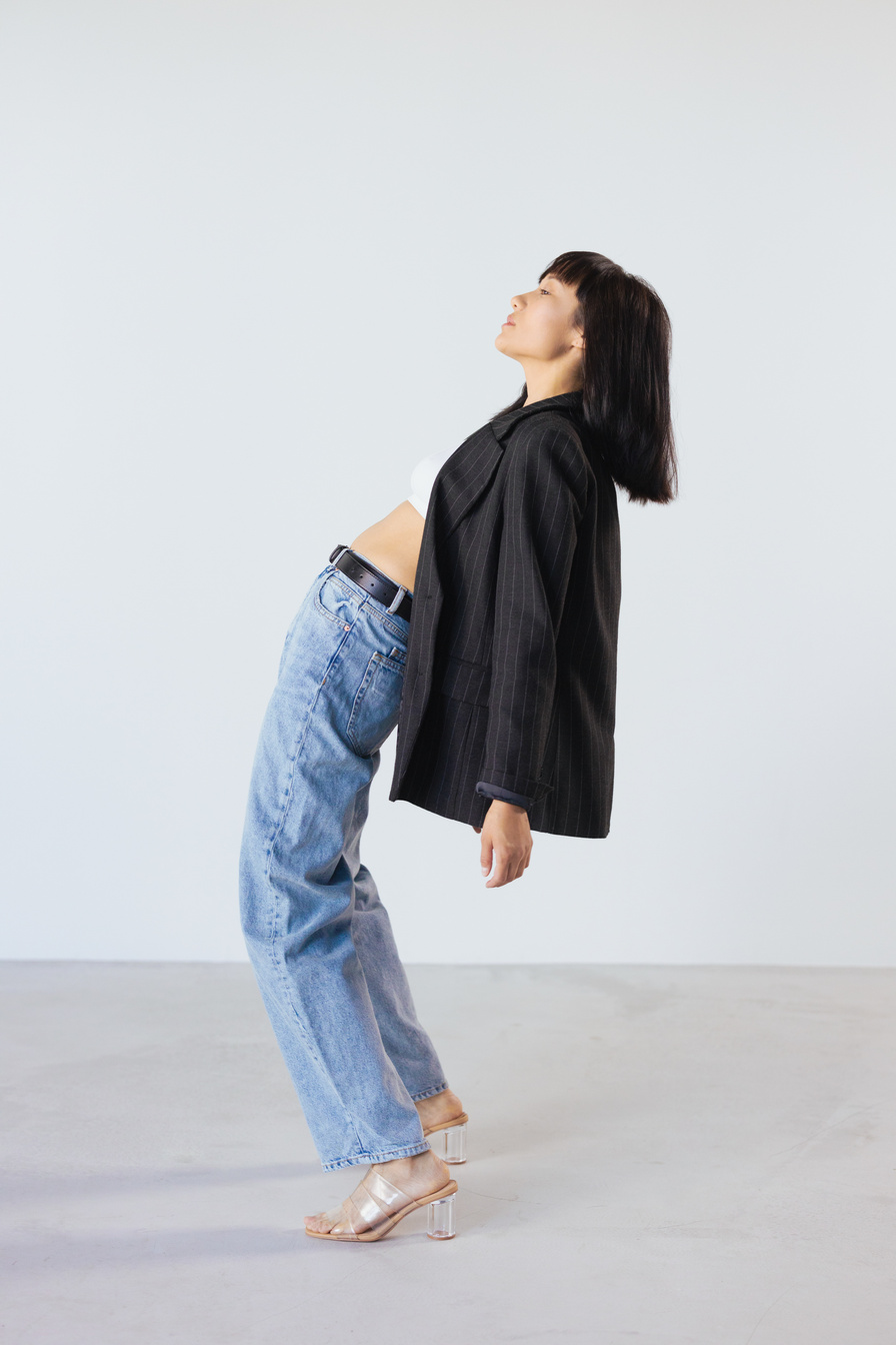 Woman in Black Long Sleeve Shirt and Blue Denim Jeans